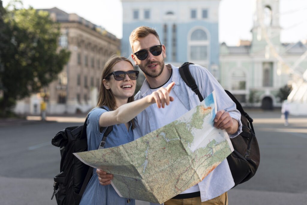 front-view-tourist-couple-pointing-something-while-holding-map