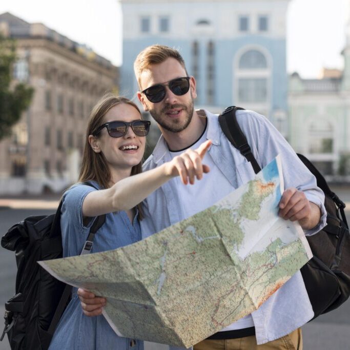 front-view-tourist-couple-pointing-something-while-holding-map